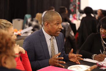 Malcolm Reid Sr engaging with leaders at a live coaching event